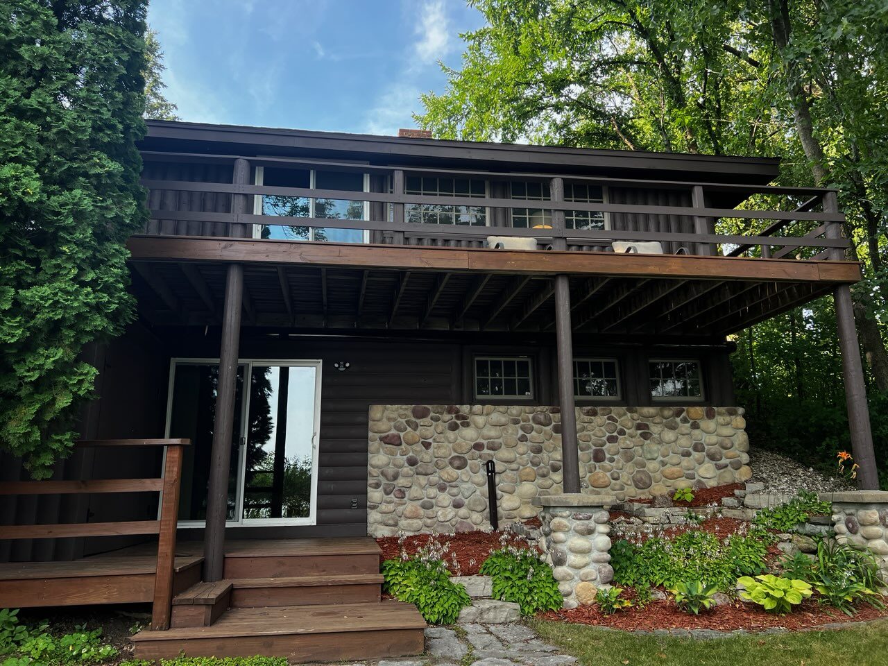 Back exterior with stone chimney base