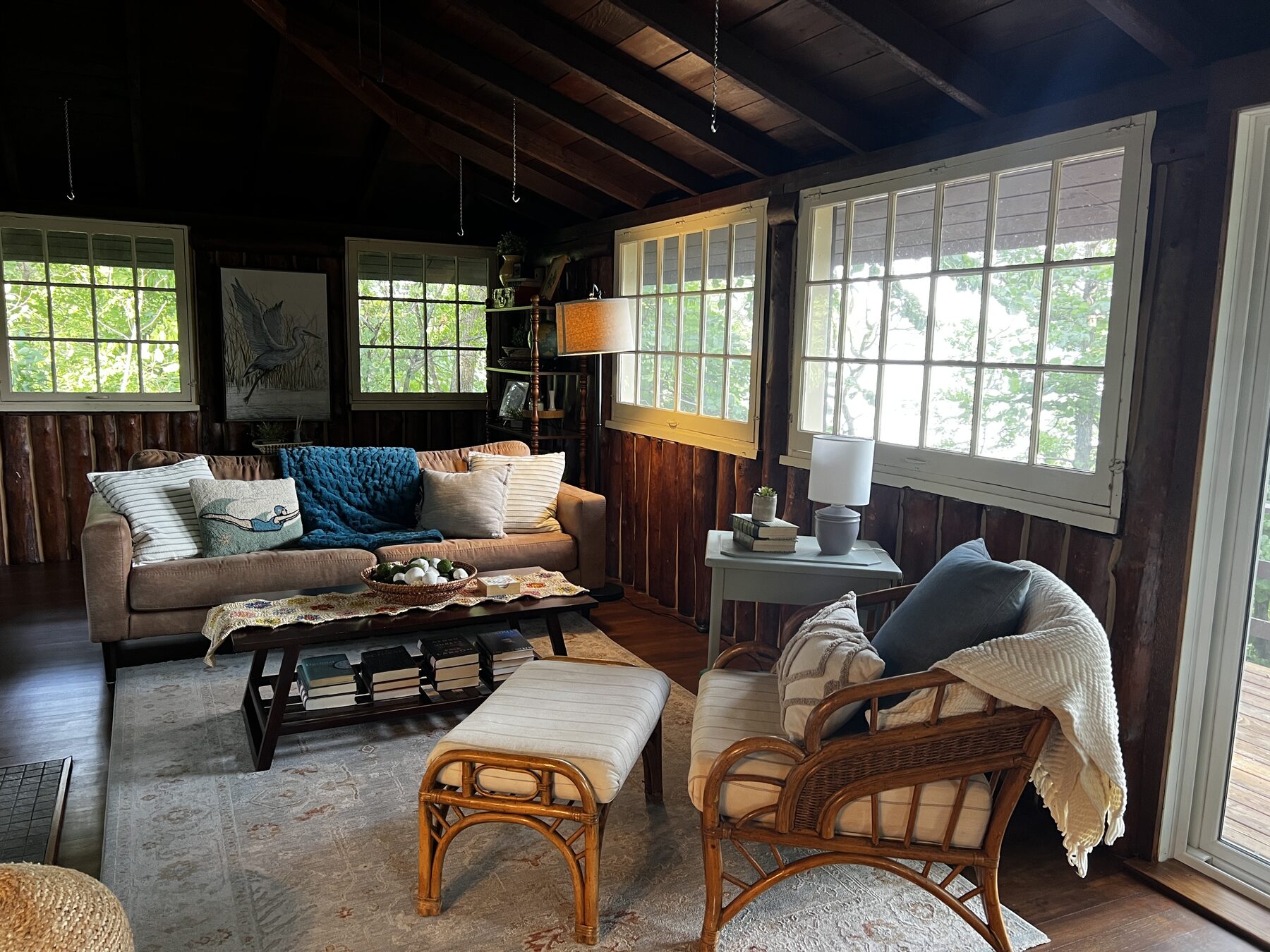 Living room with stone fireplace and lake-view windows